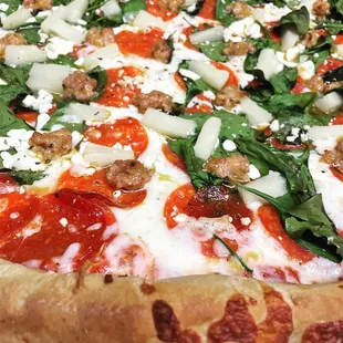 Large pizza with spinach pepperoni sausage pineapple feta