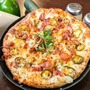 a cheese pizza with jalapenos