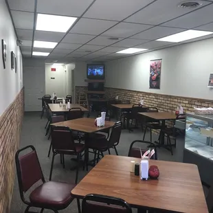 a dining area with tables and chairs