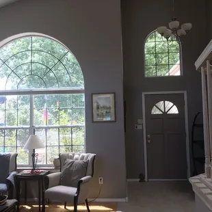 Front door, high ceilings and windows