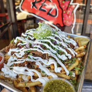 Loaded Birria Fries 
beef birria, cheese, cilantro, onions, topped w/ sour cream and guacamole