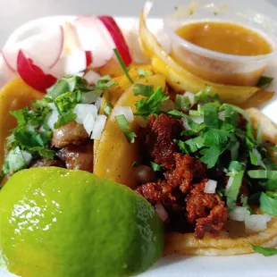 a plate of tacos and a lime