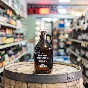 a bottle of beer on a barrel