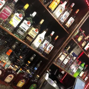 a shelf full of liquor