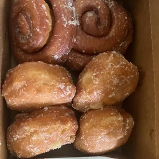 Two cinnamon rolls and lemon filled donuts