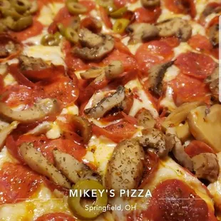 We got cheese, pepperoni, half mushrooms, half green olives.