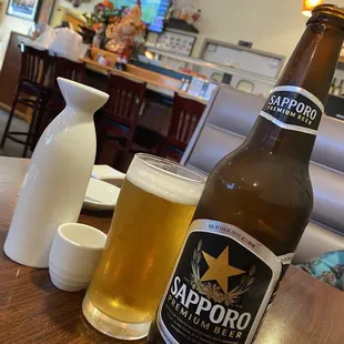 a bottle of sappor beer and a glass of beer