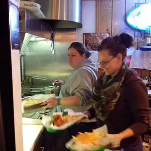 Miki Jo's cooking the tasty treats and Brie's delivering the goods. Talk about friendly!