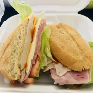 Stack sandwich. Ham , turkey, American cheese , Swiss cheese , lettuce and tomato on a French roll .