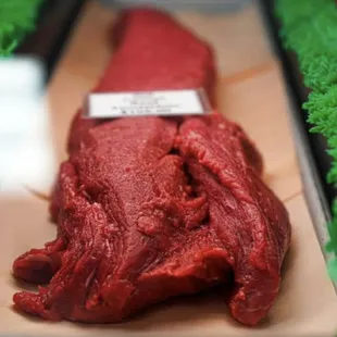 a piece of beef on a cutting board