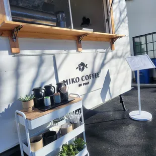 a coffee cart with plants
