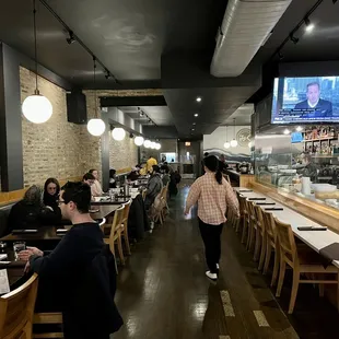 a woman walking through the dining area