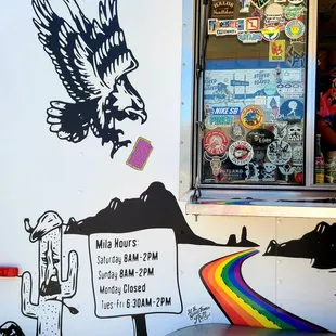 an eagle and a rainbow on the side of a food truck