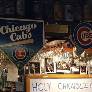 a chicago cubs sign above a bar
