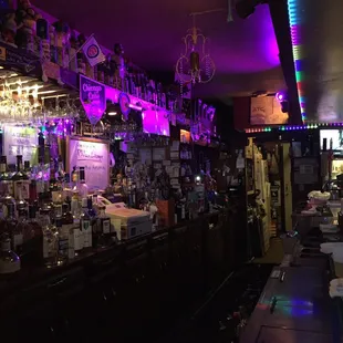 a dimly lit bar with purple lighting