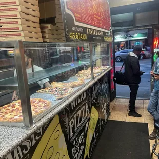 Front display of big slices of pizza!