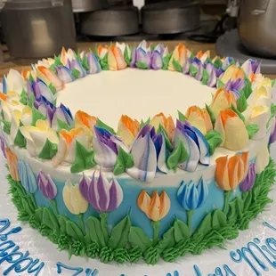 a birthday cake decorated with tulips