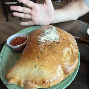 Meat Lovers Calzone- My husband held up his hand for a size comparison.