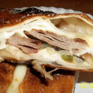 Philly Roll. Along with the meat, lots of gooey cheese, grilled onions, mushrooms, and green peppers.