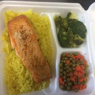 a meal of salmon, rice, peas and carrots