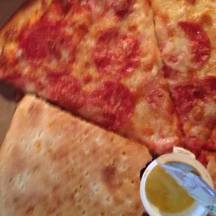 four slices of pizza with sauce