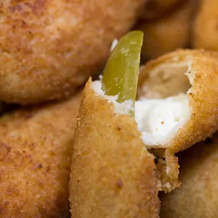 a pile of fried food with a bite taken out of it