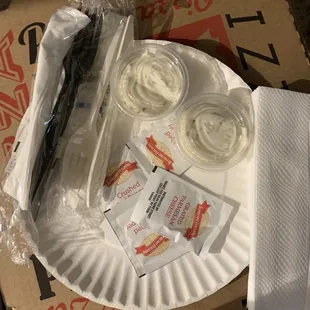 They always give you two ranches, cheese, peppers, paper plates and napkins and utensils! :)