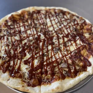 a pizza with sauce drizzle