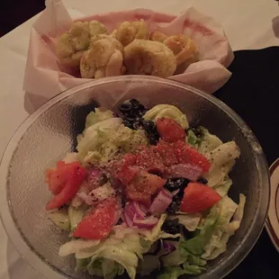 a bowl of salad and bread