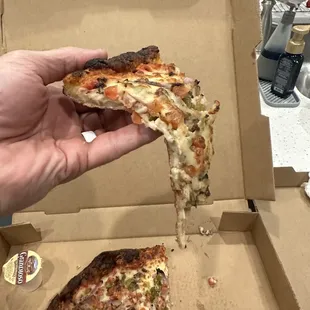 Part of crust burnt, but rest of pizza flops like wet paper towel.