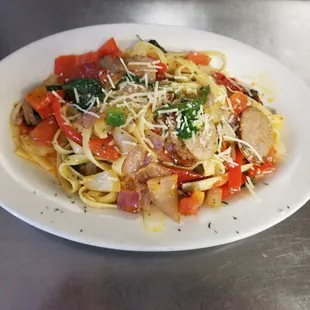 a plate of pasta with meat and vegetables