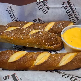 two baguets with cheese and mustard