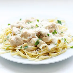 a plate of pasta with meatballs and parmesan cheese