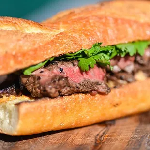 a steak sandwich on a cutting board