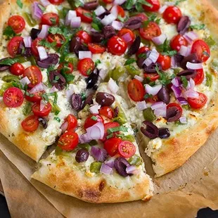 a whole pizza on a piece of parchment paper