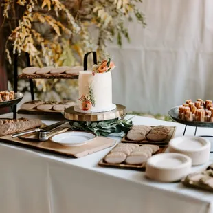 a table with a cake and desserts