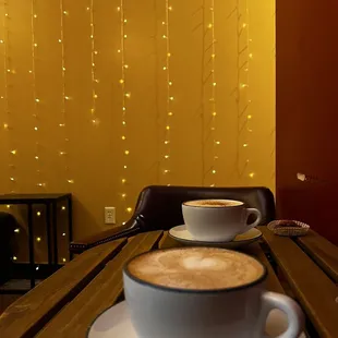 two cups of coffee on a wooden table