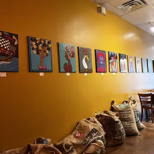 coffee bags lined up against a yellow wall