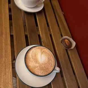 two cups of coffee on a wooden table