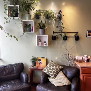 a living room with two leather chairs and a coffee table