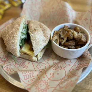 a sandwich with a side of potatoes
