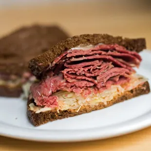Our Corned Beef Reuben: corned beef, swiss, kraut, with Russian dressing on pumpernickel