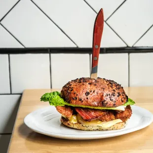 The Chicken Schnitzel BLT: Maple bacon, pickled green tomato, lettuce, mustard-mayo served on a onion roll