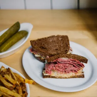 Every hero needs a sidekick, and ours has two: pickles and French fries to accompany our corned beef reuben.