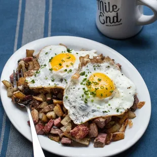 Smoked Meat Hash: Smoked brisket, potatoes, and caramelized onions, topped with fried eggs
