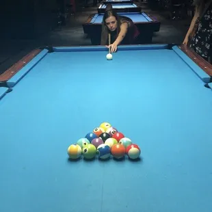 a woman playing pool