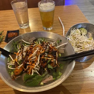 a bowl of salad and a glass of beer