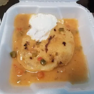 Smothered Revuelta (chicharrones and cheese) pupusa.