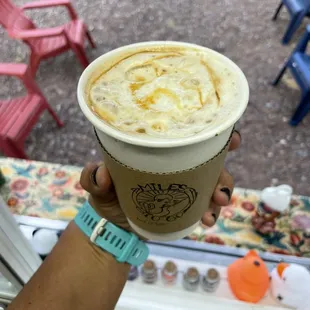 a hand holding a cup of coffee