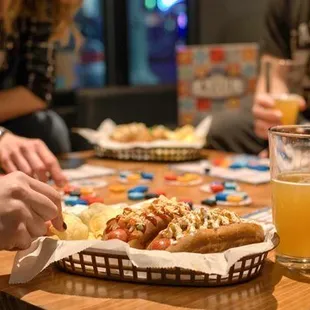 a group of people sitting around a table with food and drinks